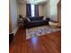 Cozy living room features a couch, throw pillows, area rug, and decorative curtains at 3898 Ridge Rd, Buford, GA 30519