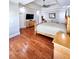 A large primary bedroom with hardwood floors, a ceiling fan, and a seating area at 3898 Ridge Rd, Buford, GA 30519