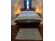 Inviting main bedroom with a plush bed, side tables with lamps, and wood bench at 3898 Ridge Rd, Buford, GA 30519