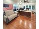 Bright office space with hardwood floors, American flag, and a large desk at 3898 Ridge Rd, Buford, GA 30519