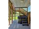 Covered patio area with a hot tub and wooden staircase for backyard enjoyment at 3898 Ridge Rd, Buford, GA 30519