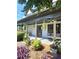 Covered porch with comfortable seating, plants, and a glimpse of the outdoors at 3898 Ridge Rd, Buford, GA 30519