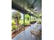 Relaxing porch space with a daybed, foliage, and a charming garden view at 3898 Ridge Rd, Buford, GA 30519