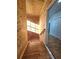 Wooden staircase with sunlight streaming through a nearby window and leading to a door at 3898 Ridge Rd, Buford, GA 30519