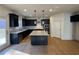 Modern kitchen with dark cabinetry, large island, and stainless steel appliances at 179 Basie Ct, Fairburn, GA 30213