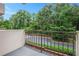 Private balcony overlooking lush green trees and parking lot at 300 Johnson Ferry Ne Rd # A203, Sandy Springs, GA 30328