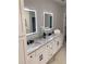 Double vanity bathroom with marble countertops and LED lit mirrors at 408 Autry St, Norcross, GA 30071