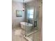 Spa-like bathroom with freestanding tub, glass shower, and marble flooring at 408 Autry St, Norcross, GA 30071