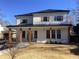 Two-story farmhouse with white siding, dark metal roof, and a welcoming front porch at 408 Autry St, Norcross, GA 30071