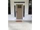 Elegant taupe front door with a glass paneled top and sidelights at 408 Autry St, Norcross, GA 30071