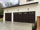 Three-car garage with dark brown doors and white trim at 408 Autry St, Norcross, GA 30071