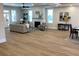 Open concept living room with hardwood floors and a cozy fireplace at 408 Autry St, Norcross, GA 30071