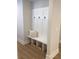 Built-in bench with storage and hooks in a light and airy mudroom at 408 Autry St, Norcross, GA 30071