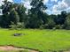Large backyard with grassy area and surrounding trees at 5595 Stagecoach Rd, Rex, GA 30273