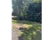 Partially grassy backyard area, trees, and shed visible at 5595 Stagecoach Rd, Rex, GA 30273