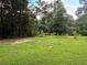 Large grassy backyard bordered by trees at 5595 Stagecoach Rd, Rex, GA 30273