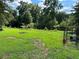 Spacious backyard with grassy area, trees, and dog kennel at 5595 Stagecoach Rd, Rex, GA 30273