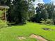 Backyard with grassy area and a fire pit at 5595 Stagecoach Rd, Rex, GA 30273