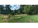 Backyard with grassy area and surrounding trees at 5595 Stagecoach Rd, Rex, GA 30273