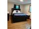 Bright bedroom with hardwood floors and built-in shelving at 5595 Stagecoach Rd, Rex, GA 30273