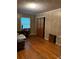 Simple bedroom with wood floors and double-door closet at 5595 Stagecoach Rd, Rex, GA 30273