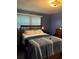Spacious bedroom with wood floors and large window at 5595 Stagecoach Rd, Rex, GA 30273