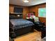 Cozy bedroom with wood-paneled walls and hardwood floors at 5595 Stagecoach Rd, Rex, GA 30273