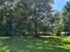 Ranch home surrounded by tall trees, sunny day at 5595 Stagecoach Rd, Rex, GA 30273
