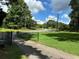 Landscaped yard with a gated entrance and paved driveway at 5595 Stagecoach Rd, Rex, GA 30273