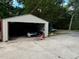Detached garage with car and storage items inside at 5595 Stagecoach Rd, Rex, GA 30273