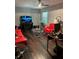 Living room with red couches, dark hardwood floors, and a TV at 5595 Stagecoach Rd, Rex, GA 30273