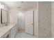 Bright bathroom featuring double sinks with white countertops, and a tiled shower at 4315 Orchard Park Ct, Stone Mountain, GA 30083