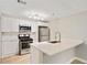 Modern kitchen with stainless steel appliances, white cabinets, and quartz countertops at 4315 Orchard Park Ct, Stone Mountain, GA 30083