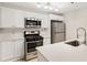 Bright kitchen featuring stainless steel appliances, modern lighting, and island seating at 4315 Orchard Park Ct, Stone Mountain, GA 30083