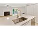 Modern kitchen with quartz countertops, stainless steel sink, and open to living room at 4315 Orchard Park Ct, Stone Mountain, GA 30083