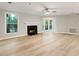 Spacious living room with a fireplace, ceiling fan, and ample natural light at 4315 Orchard Park Ct, Stone Mountain, GA 30083