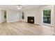 Bright living room boasts a fireplace, ceiling fan, and views of the outdoors at 4315 Orchard Park Ct, Stone Mountain, GA 30083