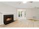 Cozy living room with a classic fireplace, hardwood floors, and natural light at 4315 Orchard Park Ct, Stone Mountain, GA 30083