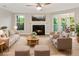 Inviting living room with a cozy fireplace, ceiling fan, and ample natural light at 4315 Orchard Park Ct, Stone Mountain, GA 30083