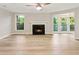 Spacious living room with modern ceiling fan, fireplace, and large windows at 4315 Orchard Park Ct, Stone Mountain, GA 30083