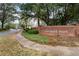 Brick sign for Orchard Park community featuring lush trees and greenery in a peaceful residential setting at 4315 Orchard Park Ct, Stone Mountain, GA 30083