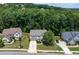 Aerial view of house and surrounding neighborhood, showcasing curb appeal and wooded area at 138 Stargaze Rdg, Canton, GA 30114