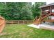 Spacious backyard with a wooden deck, stairs, and a fenced area at 138 Stargaze Rdg, Canton, GA 30114