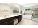 Spa-like bathroom featuring double sinks, a soaking tub, and a walk-in shower at 138 Stargaze Rdg, Canton, GA 30114