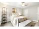 Cozy bedroom with a queen bed, stylish decor, and a floor lamp at 138 Stargaze Rdg, Canton, GA 30114