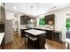 Modern kitchen with dark cabinetry, a large island, and stainless steel appliances at 138 Stargaze Rdg, Canton, GA 30114