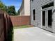 Home's backyard with concrete patio, gray siding, and fenced yard at 5015 Renvyle Dr. (Lot 12) Dr, Atlanta, GA 30339