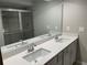 Bathroom featuring a double sink vanity with modern faucets, framed mirror, and a walk-in shower at 5015 Renvyle Dr. (Lot 12) Dr, Atlanta, GA 30339