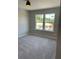 Bright bedroom with grey carpet and large window at 5015 Renvyle Dr. (Lot 12) Dr, Atlanta, GA 30339