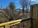 View of the backyard from the wood deck, showcasing lush trees and houses in the distance at 5015 Renvyle Dr. (Lot 12) Dr, Atlanta, GA 30339